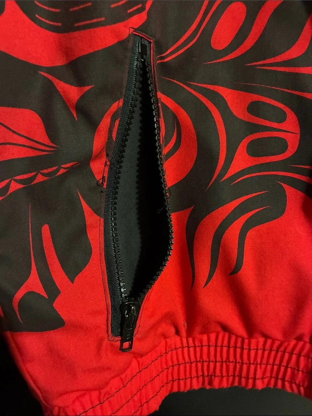 Red Puffer Jacket with Black Graphic Detailing